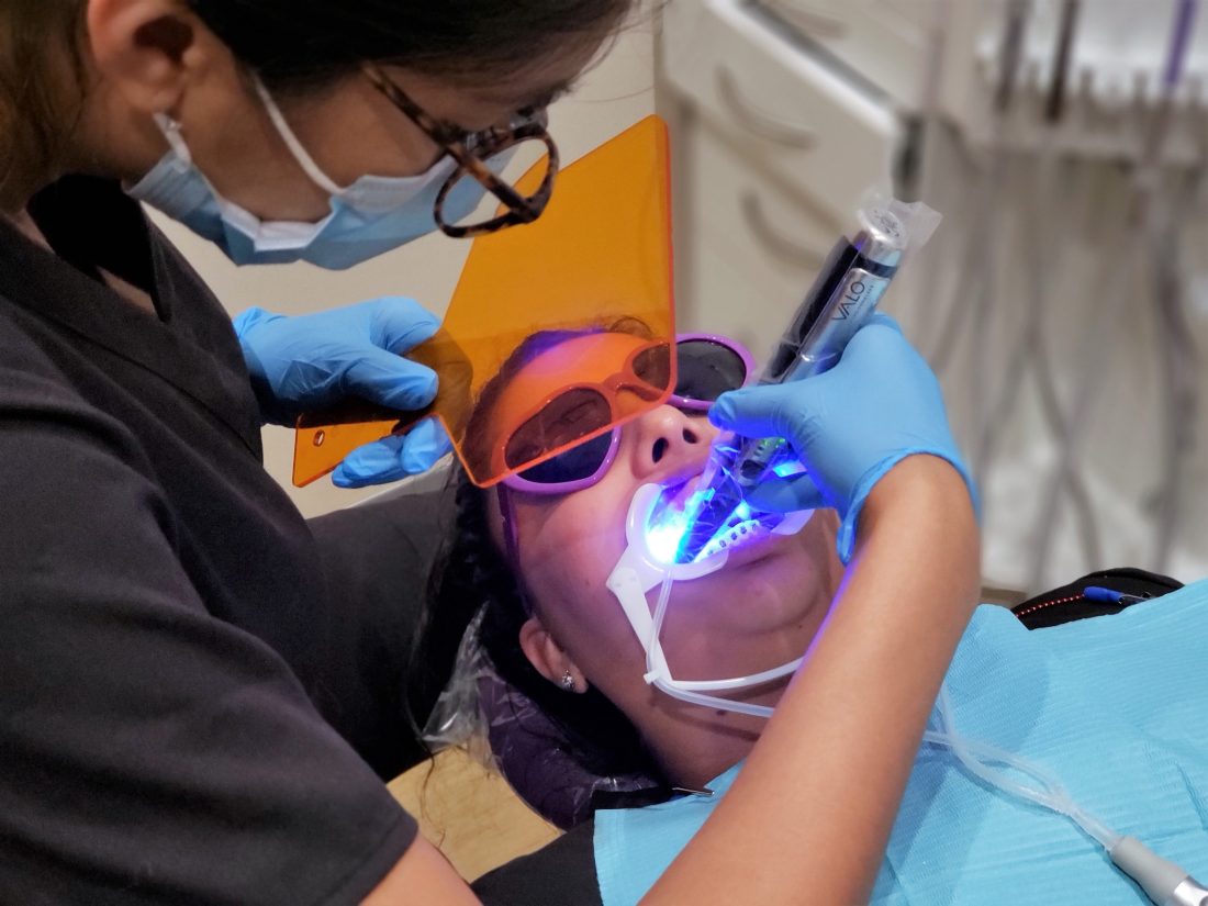 orthodontist putting on braces